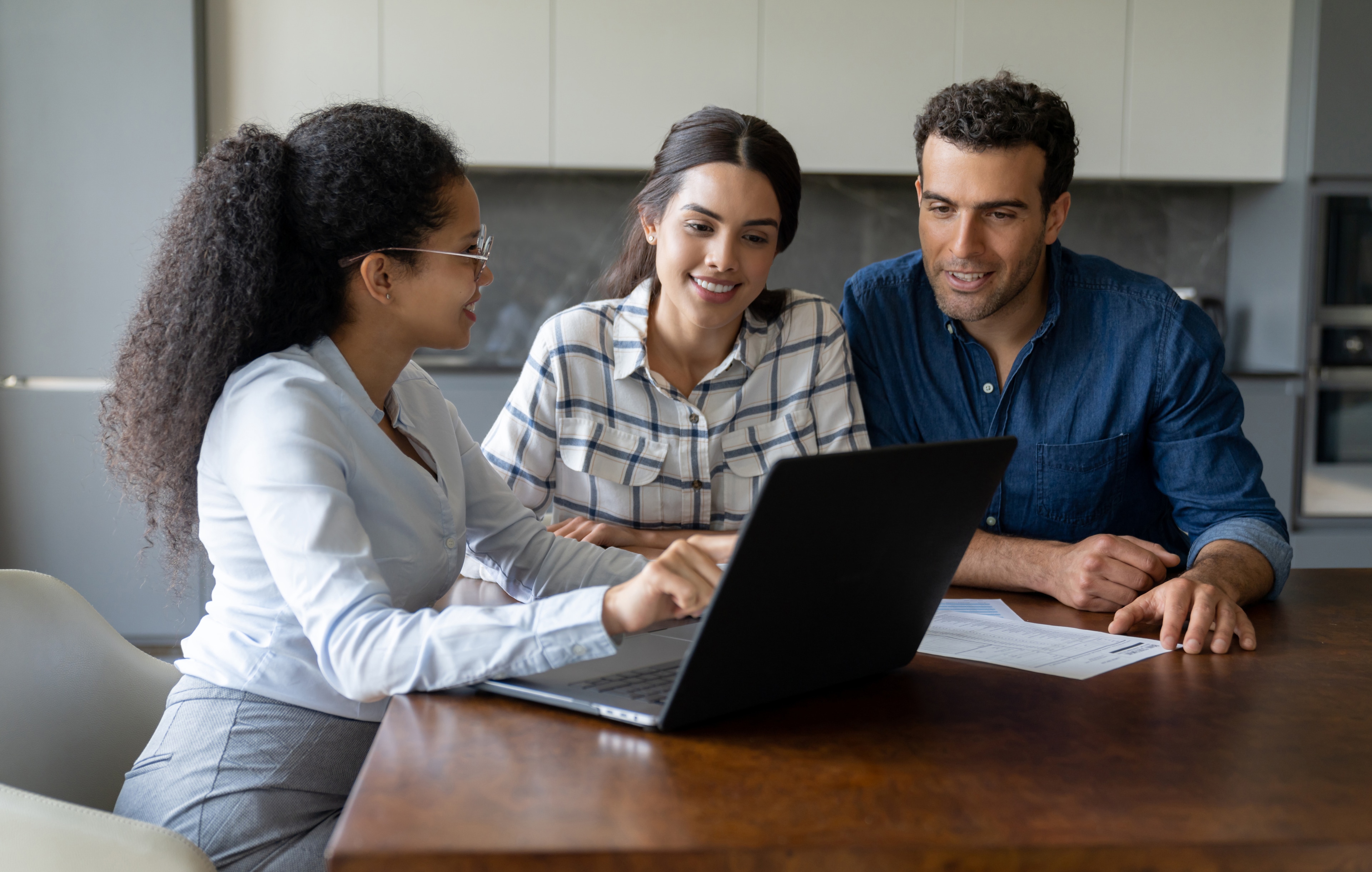A group of people looking at a laptop