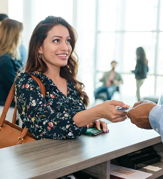 Woman handing her credit card to a cashier