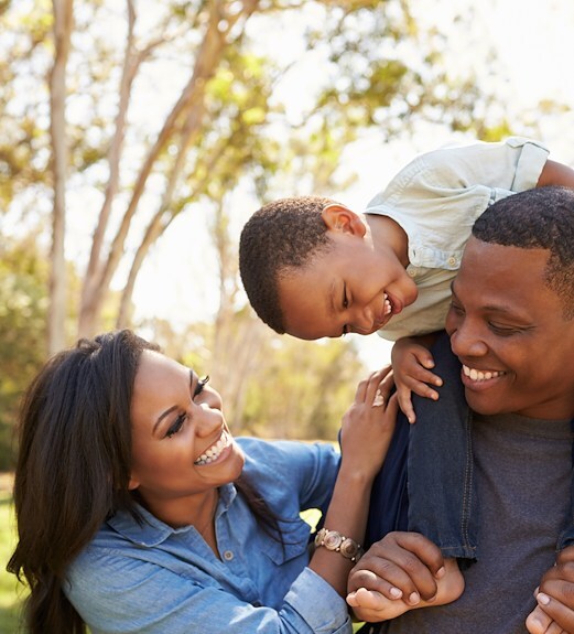 Family playing with their young son in their backyard