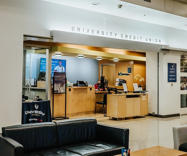 Interior of a University Credit Union branch with service counters and seating area