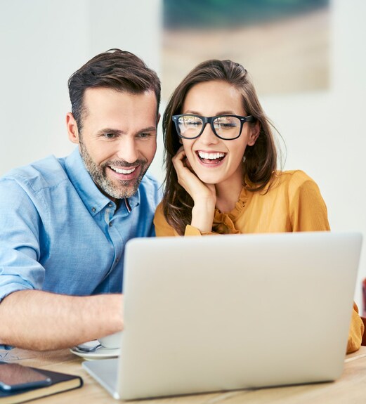 Couple scheduling a financial services appointment together on their laptop