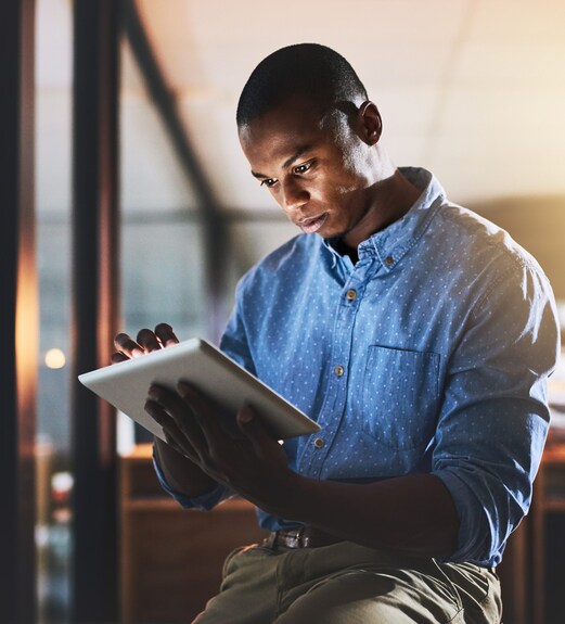 Man intently checking his tablet for a phish alert