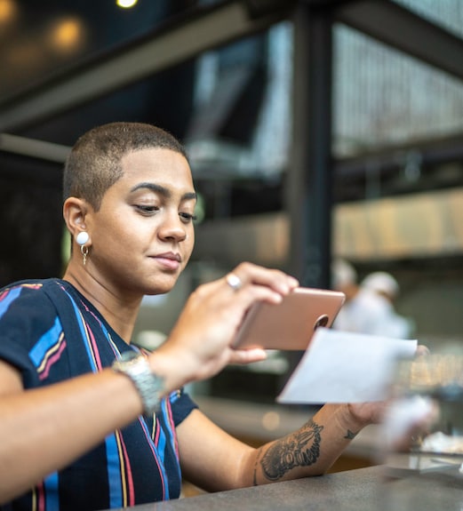 Woman using her phone to make a mobile deposit