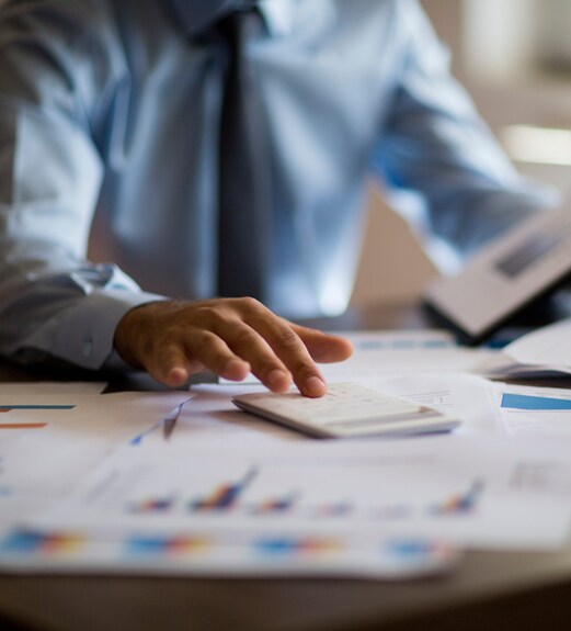 Close up view of a person reviewing charts and data