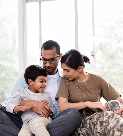 A young military family sitting together