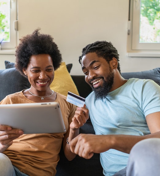 Smiling couple making an online purchase