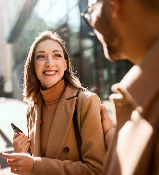 Smiling woman crossing the street with a friend