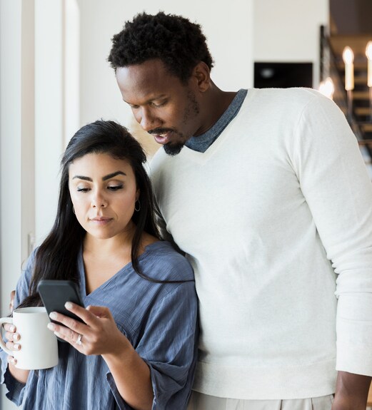 Couple checking a fraud alert on their phone