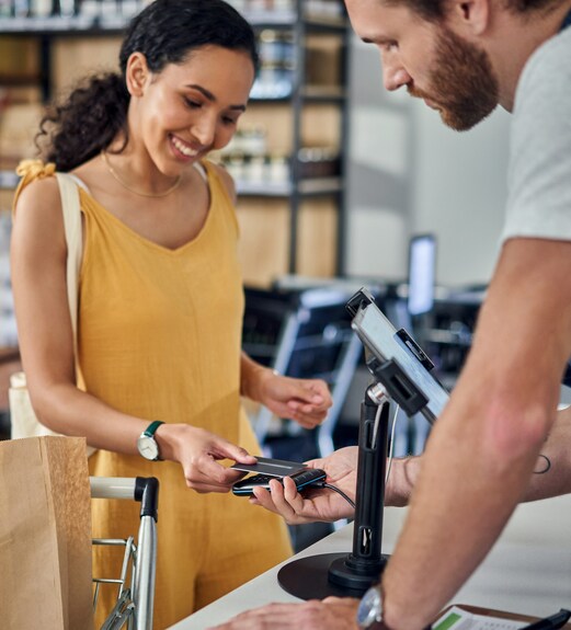 Woman making a tap payment with her debit card