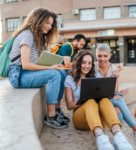 Group of college students gathred together outside on campus