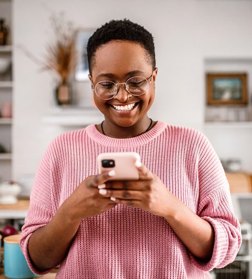 Young woman smiling checking her credit score on her phone