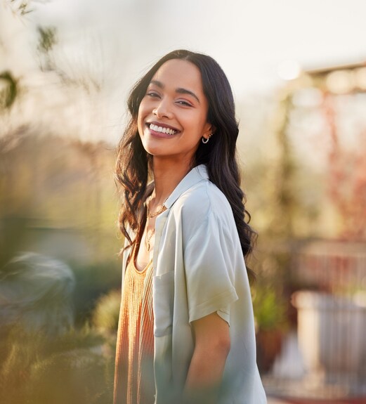 Smiling woman standing in an outdoor garden