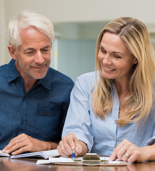 Husband and wife sitting together reviewing their retirement plans and options