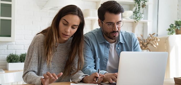 Young couple checking their finances together online