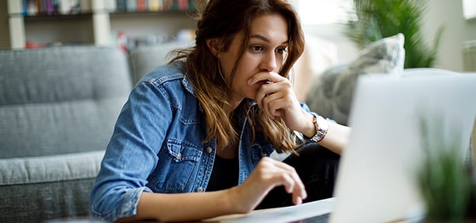 Woman looking concerned at her laptop