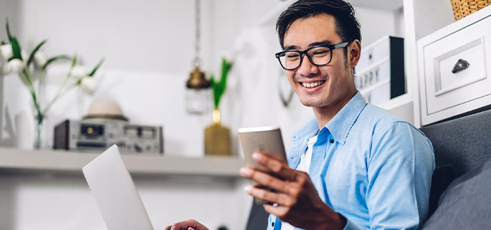 Man with glasses looking at a notification on his phone