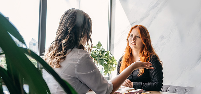 Young woman having a sit down meeting with a financial advisor