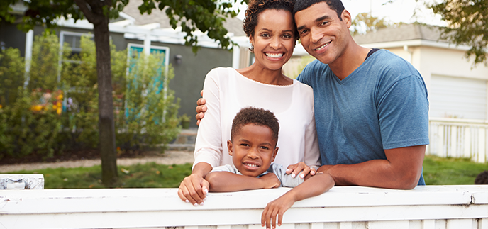 Family standing together outside their home
